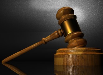 Judges timber gavel and timber block on a desk