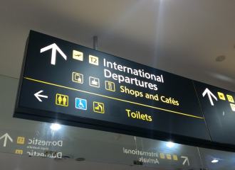 Overhead Wayfinding sign in an airport that says INTERNATIONAL DEPARTURES