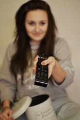 Woman hold a remote control and pointing it